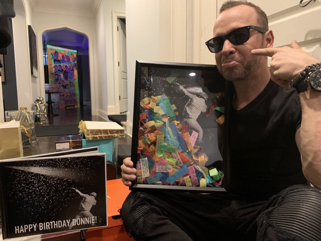 Donnie Wahlberg looking at gifts from his fans