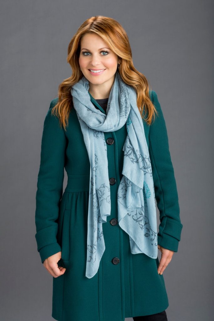 Teal winter jacket on Candace Cameron for Christmas Under Wraps