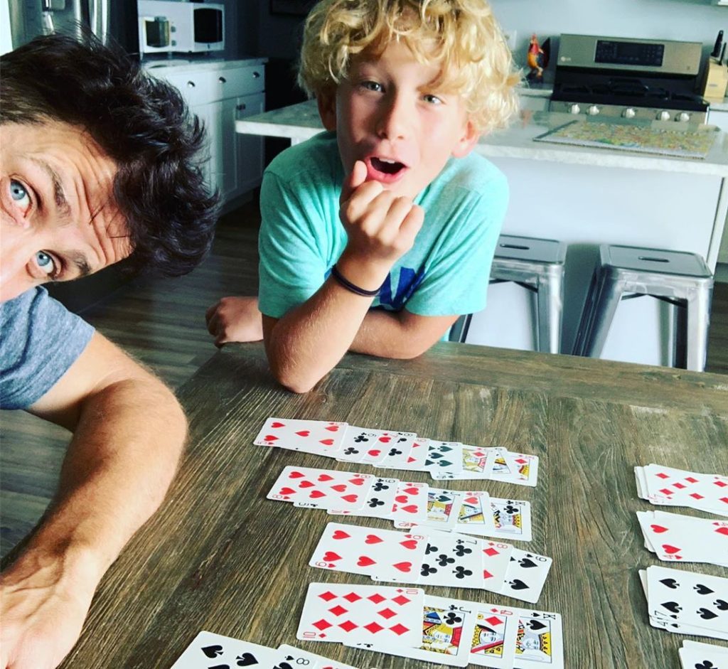 Joey McIntyre plays a card game with son Rhys